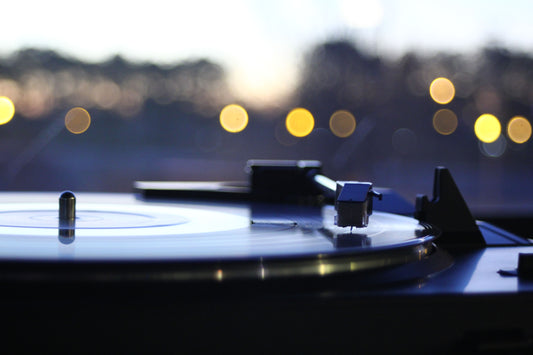 A stylus resting on a vinyl record on a turntable
