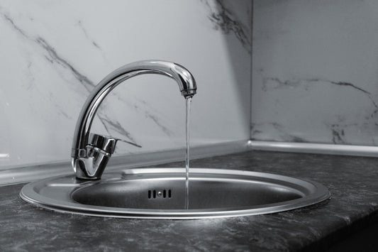 Water running from a chrome kitchen faucet