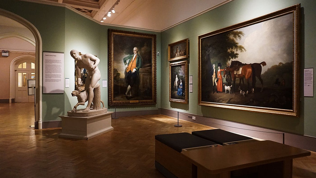 Framed paintings and a marble sculpture in an art gallery