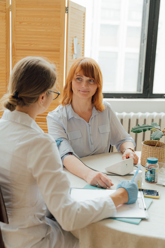 Two women speaking during a clinical consultation
